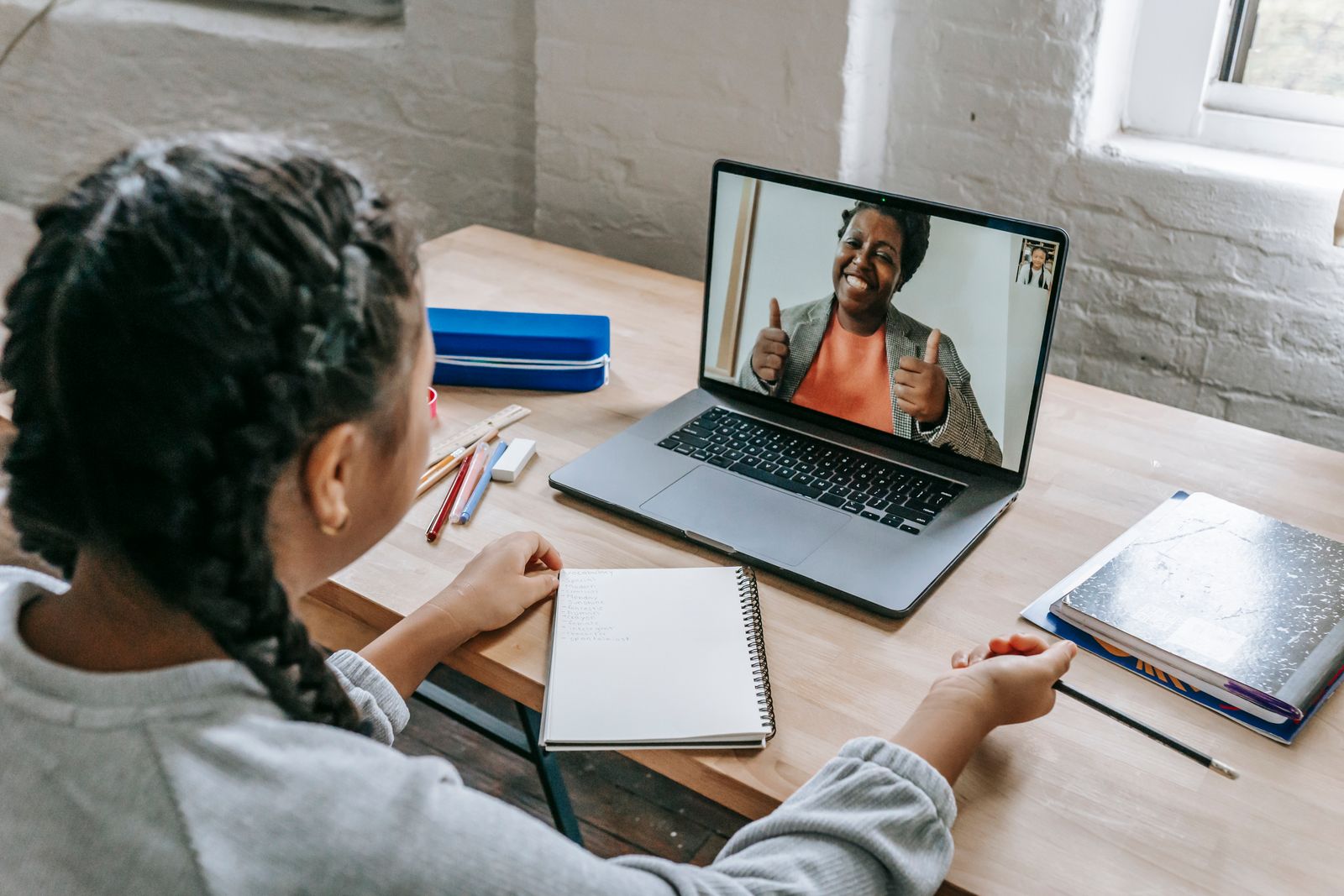 International student studying online with teacher support